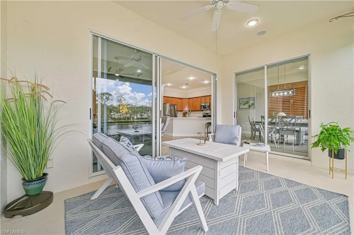 View of patio with ceiling fan and outdoor dining area
