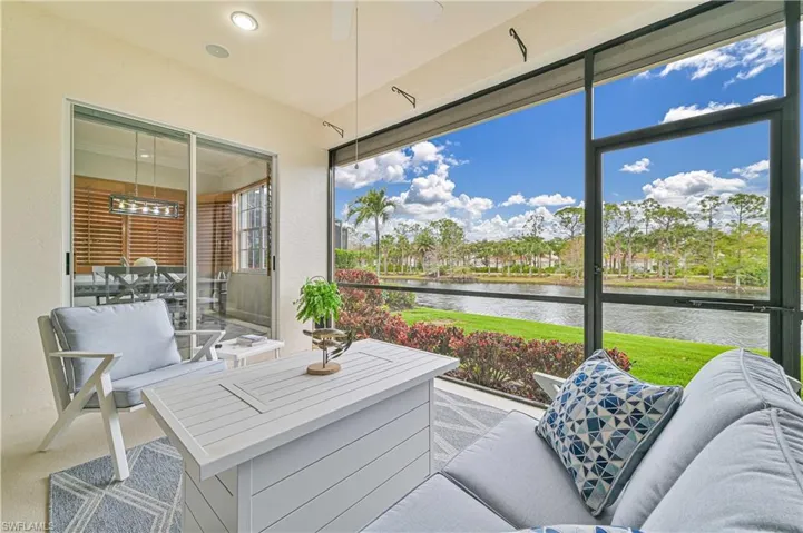 Sunroom with ceiling fan, a water view, and an outdoor lounge area