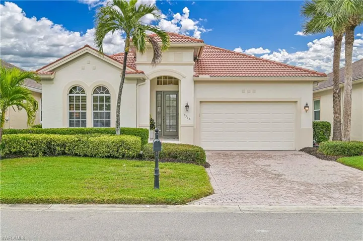 Mediterranean / spanish-style home featuring an attached garage, stucco siding, decorative driveway, and a tiled roof