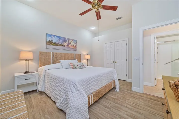 Bedroom featuring light wood-style flooring, a closet, and ceiling fan