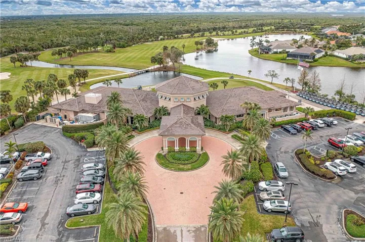 Aerial view of residential area with a large body of water and a golf course
