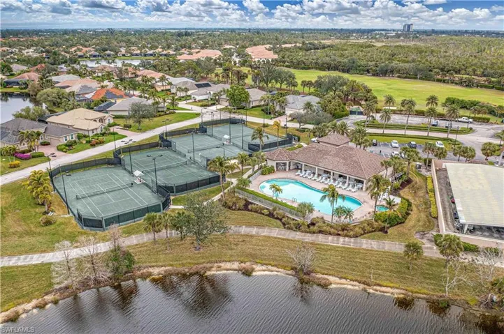 Bird's eye view of a nearby body of water and a pool area