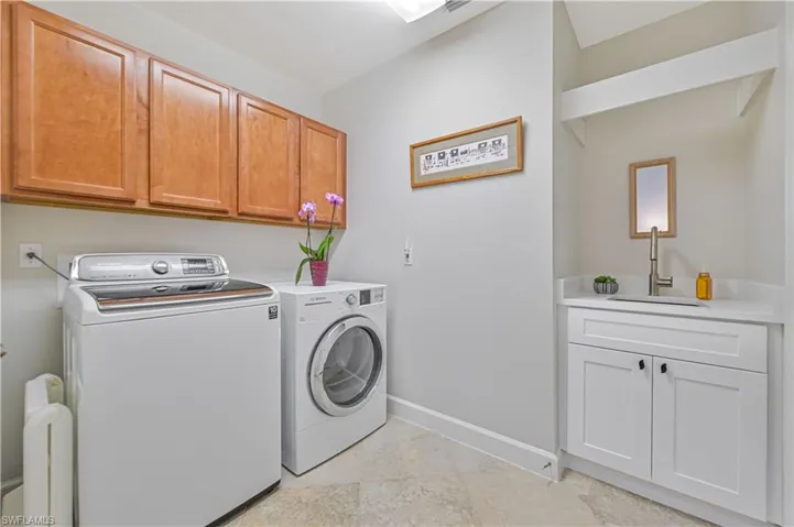 Laundry area with cabinet space and separate washer and dryer