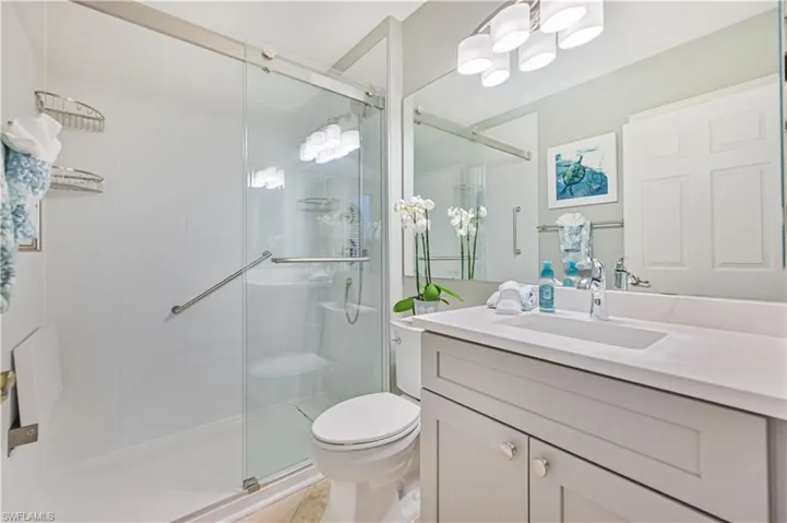 Bathroom featuring vanity and a shower stall