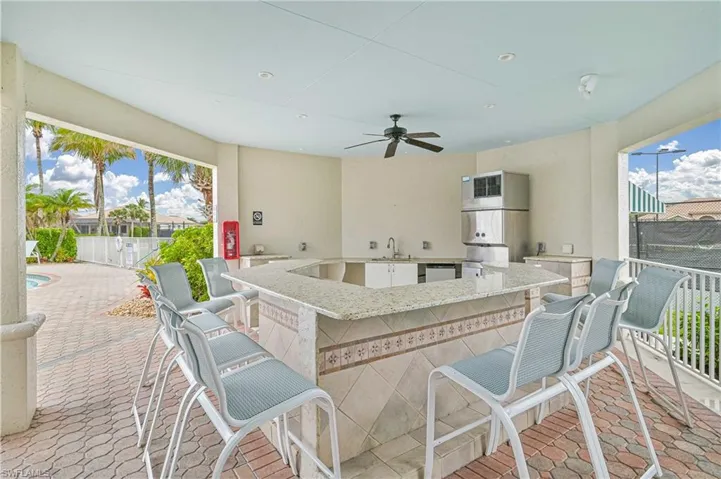 View of patio / terrace with ceiling fan and an outdoor kitchen