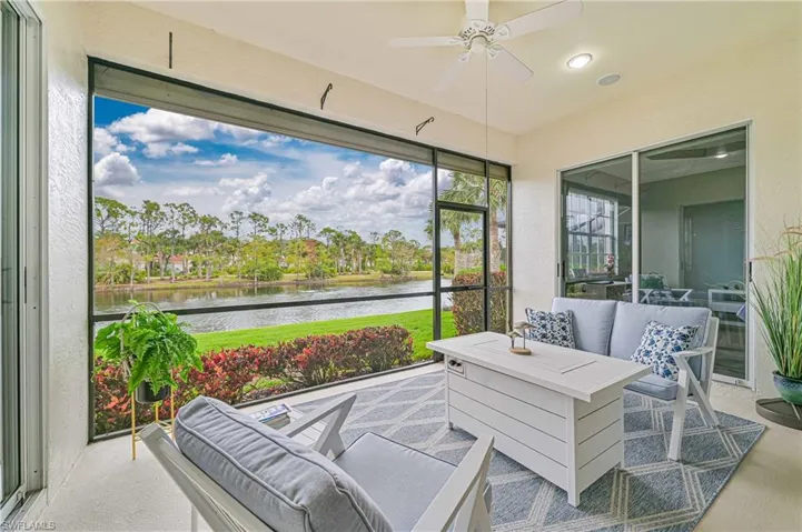 Sunroom / solarium with outdoor lounge area, ceiling fan, and a water view