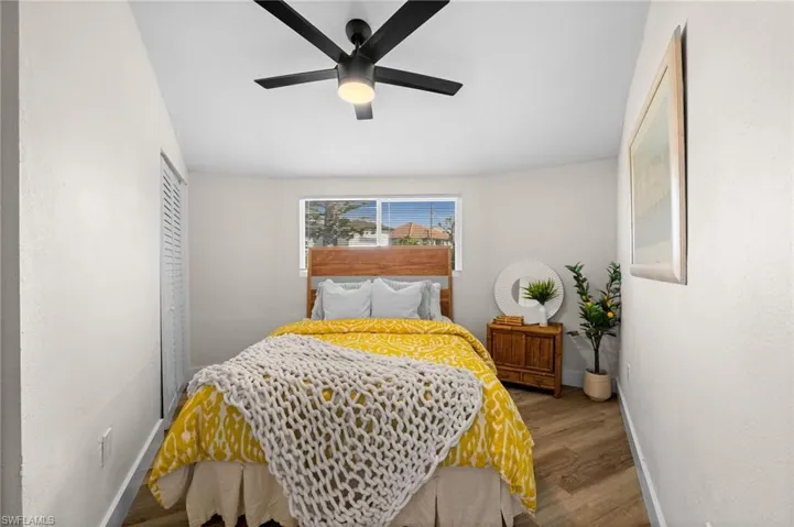 Bedroom featuring a closet, wood finished floors, and ceiling fan