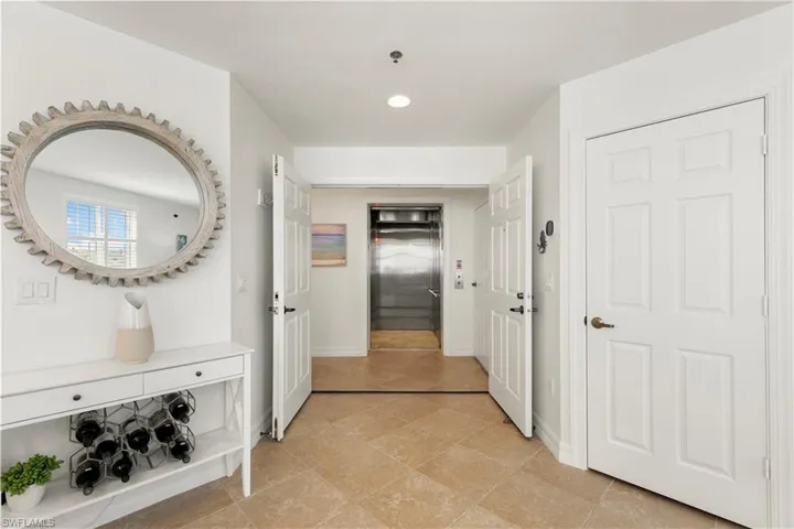 Hallway featuring elevator and recessed lighting
