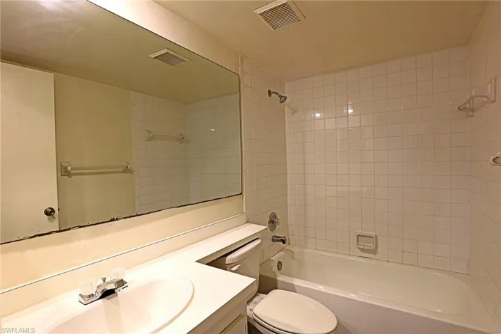 Bathroom with vanity and tub / shower combination