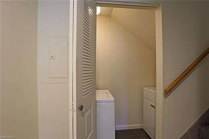 Laundry room with electric panel and independent washer and dryer