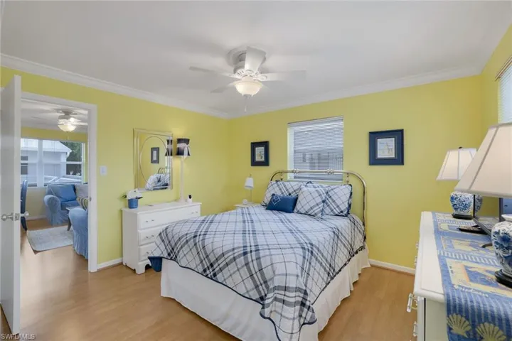 Bedroom featuring multiple windows, light hardwood / wood-style floors, and ceiling fan