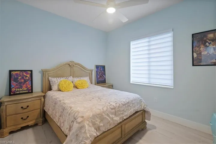 Bedroom with light wood-type flooring and a ceiling fan