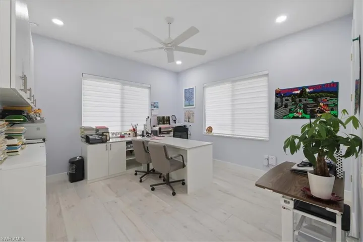 Office space with light wood-style flooring, recessed lighting, and ceiling fan