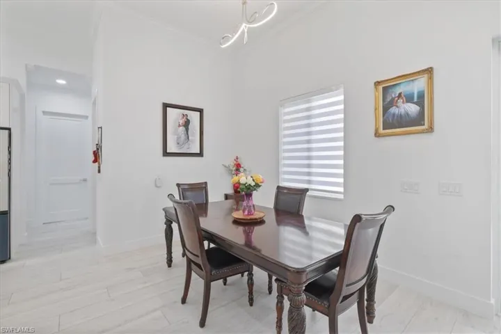Dining room featuring crown molding and light wood finished floors