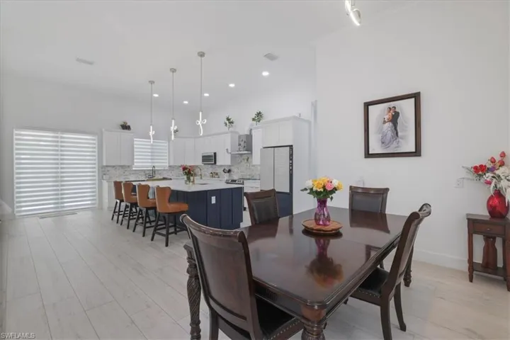 Dining area featuring light wood-style flooring, recessed lighting, and crown molding