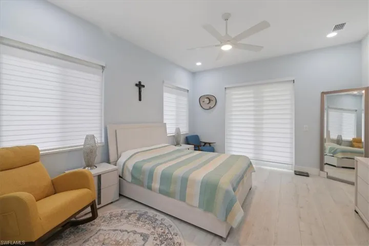 Bedroom featuring light wood-type flooring, recessed lighting, and ceiling fan