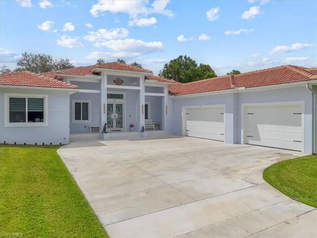 Mediterranean / spanish home featuring stucco siding, concrete driveway, a tile roof, and a garage