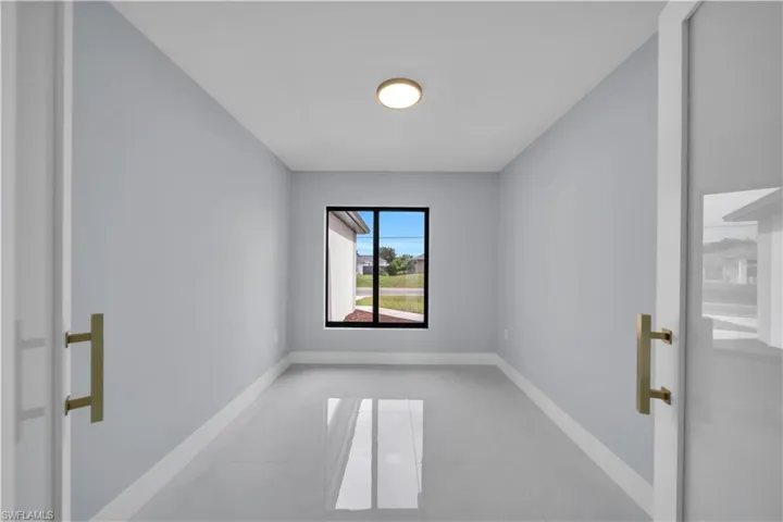 Neutral-toned walls complement the polished tile flooring, illuminated by a ceiling-mounted light fixture