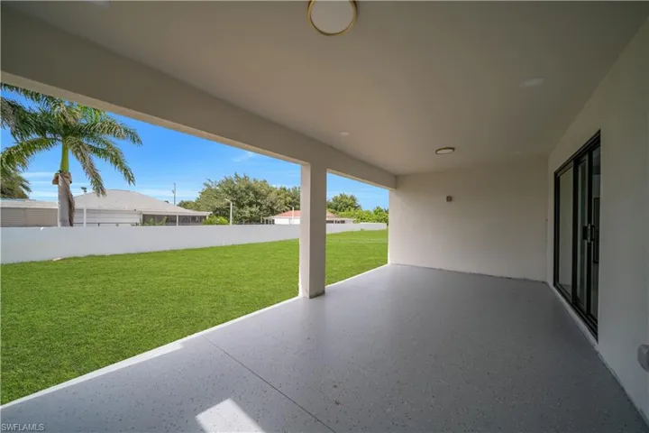 Covered patio featuring a speckled concrete surface, recessed lighting, and a modern ceiling fixture