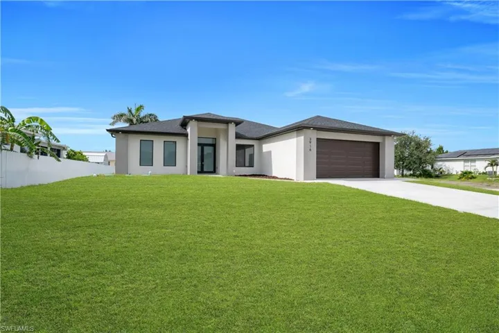 Contemporary single-story residence featuring a dark asphalt shingle roof and a light-colored stucco exterior