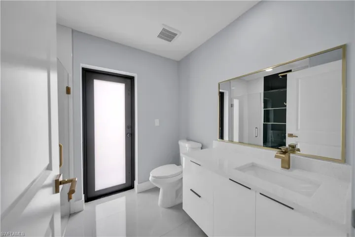 Contemporary bathroom featuring a floating vanity with a white countertop and integrated sink