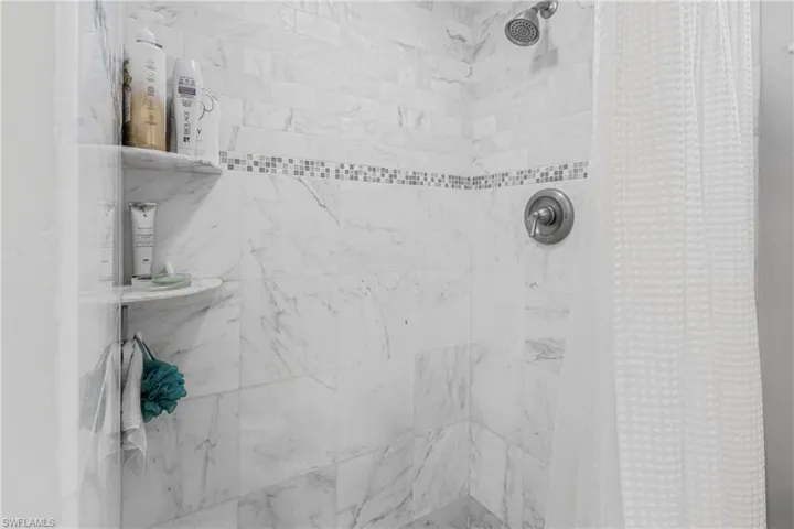 Bathroom view of a tile shower