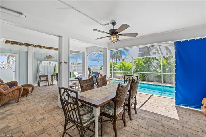 Sunroom featuring a ceiling fan, outdoor dining space, and healthy amount of natural light