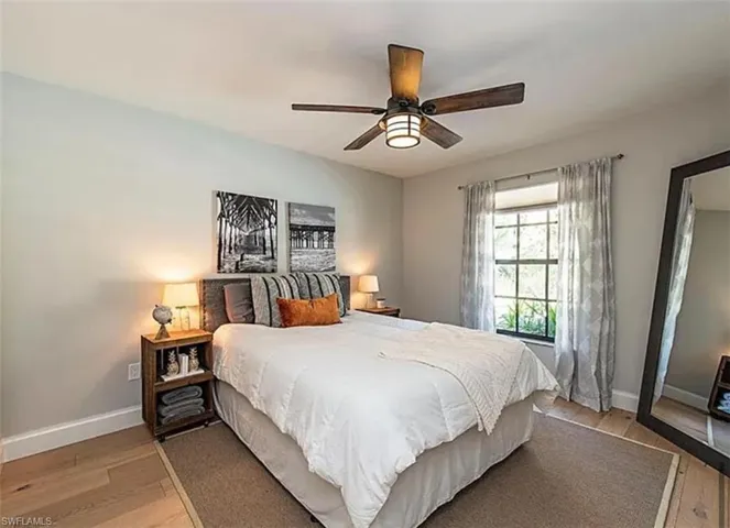 Bedroom with light wood-style floors and a ceiling fan