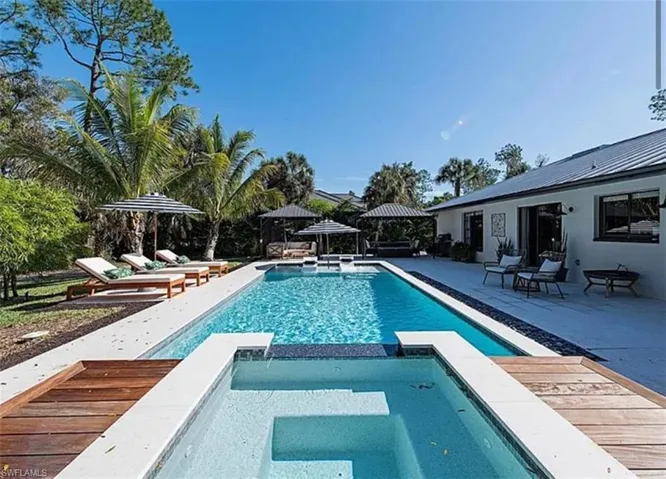 Combined pool / hot tub featuring a gazebo and a patio area
