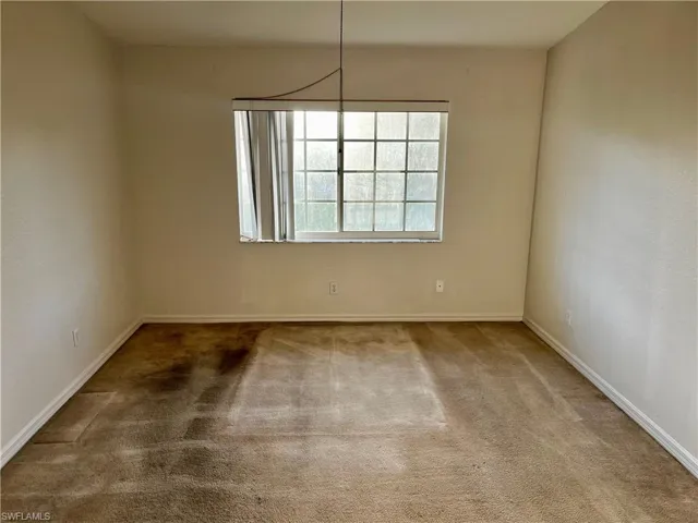 Unfurnished room featuring carpet flooring and baseboards