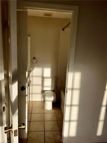Bathroom featuring tub / shower combination and light tile patterned floors