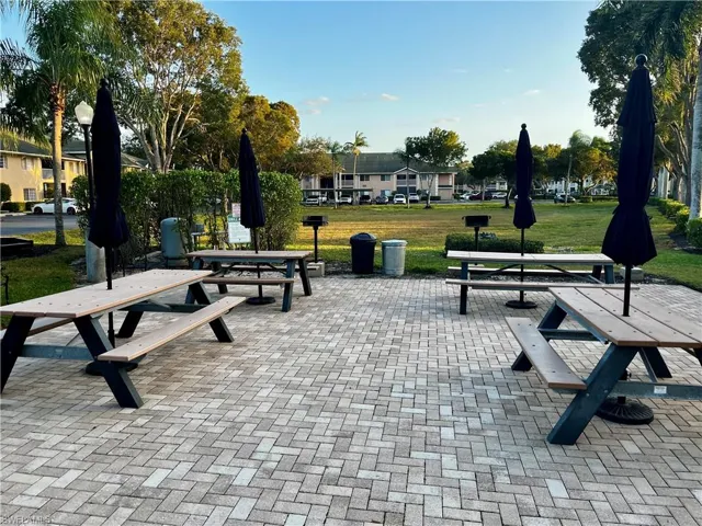 Surrounding community with a lawn and a patio area