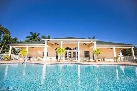 Community pool featuring a patio, clubhouse, and exercise room.