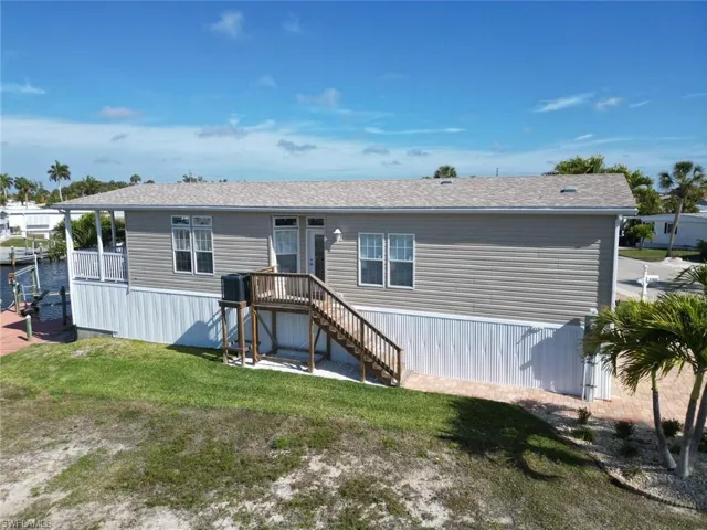 View of front of house with a front yard and stairway