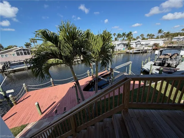 Dock area with a water view and boat lift