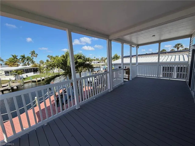 Wooden terrace featuring a sunroom and a water view
