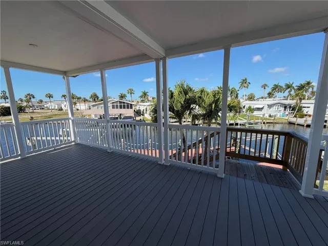Wooden terrace featuring a residential view and a water view
