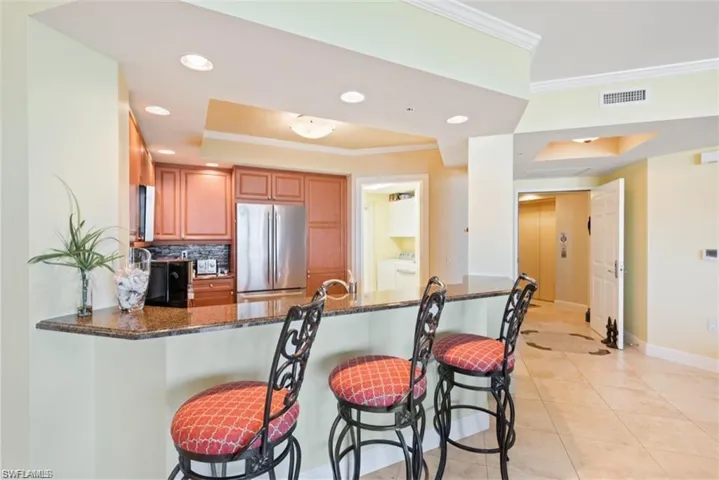Breakfast bar seating. Private elevator entry in background.