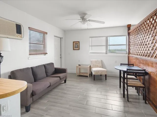 Living area featuring a ceiling fan and wood finish floors