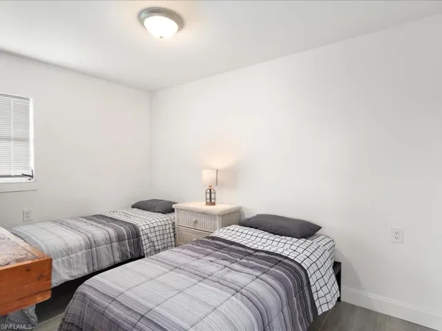 Bedroom with baseboards and wood finished floors