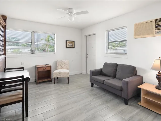 Living area featuring ceiling fan and wood tiled floors