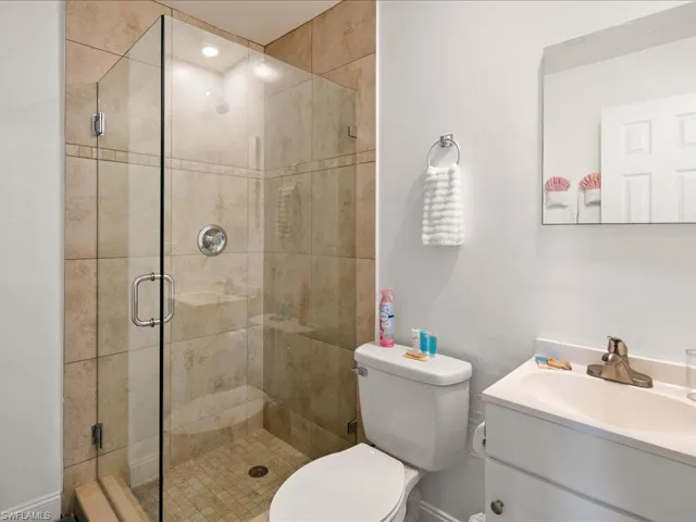 Full bathroom featuring a shower stall and vanity