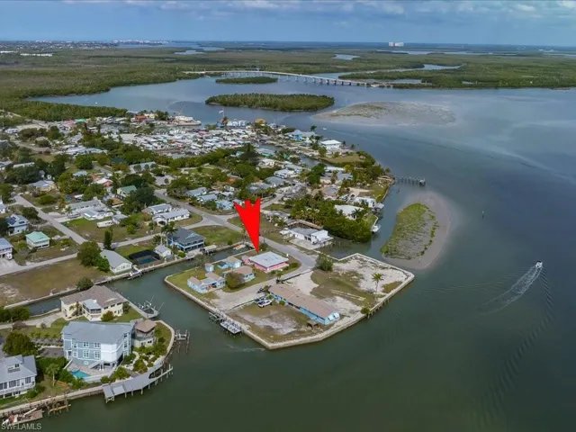 Aerial overview of property's location featuring a large body of water and nearby suburban area