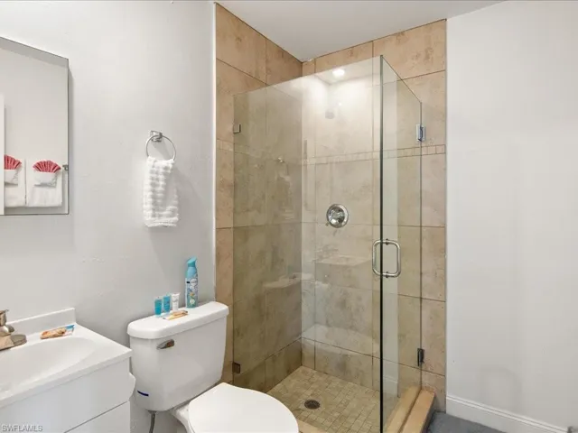 Full bath featuring a shower stall and vanity