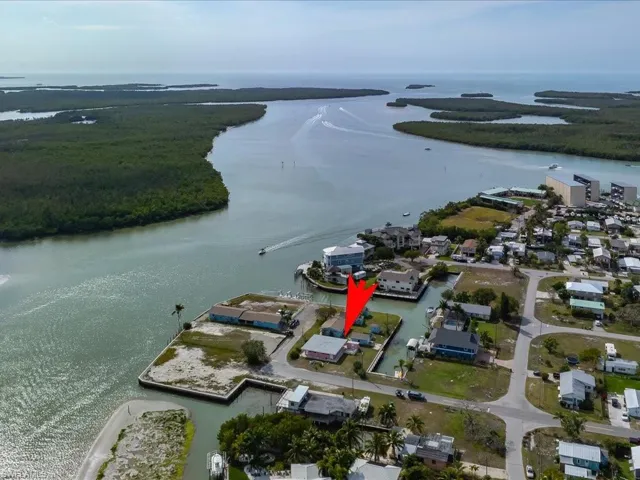 Aerial view of property's location featuring a large body of water