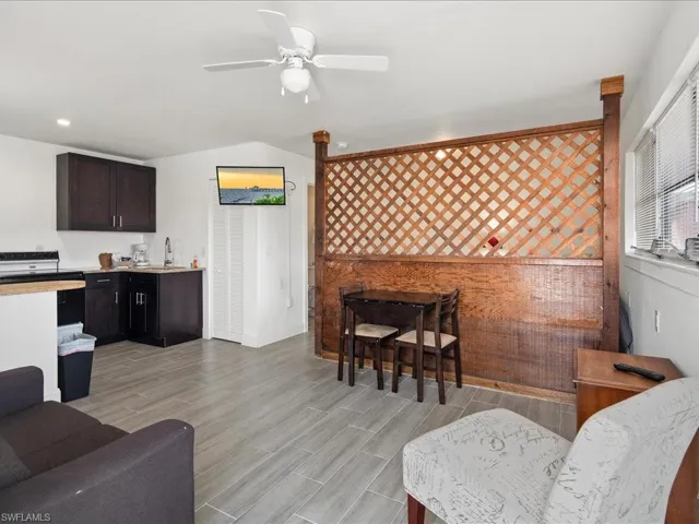 Living room with ceiling fan and wood tiled floors