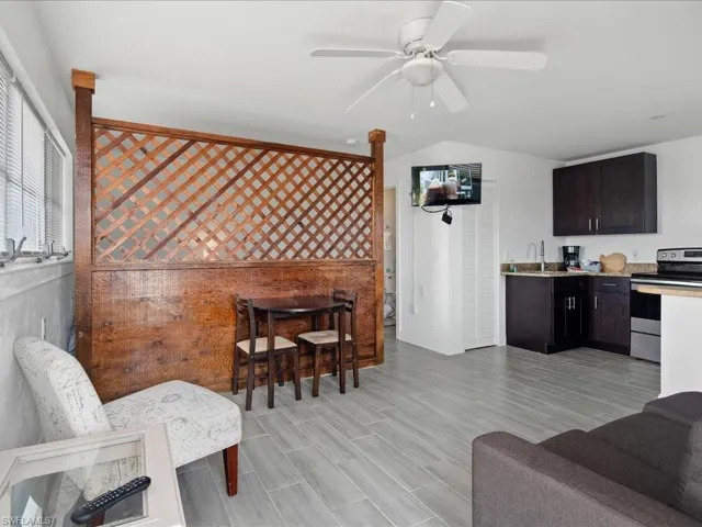 Living area with ceiling fan and wood tiled floors
