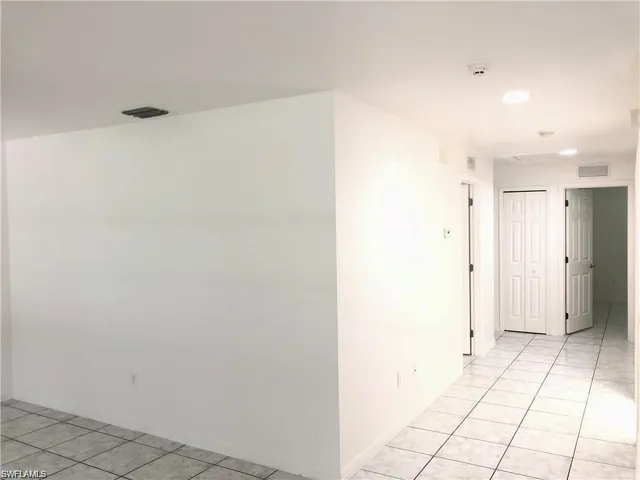Hall featuring light tile patterned flooring