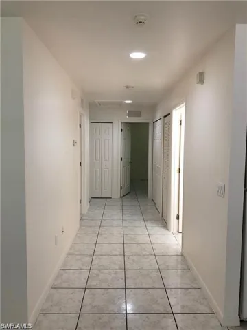 Hallway featuring light tile patterned flooring