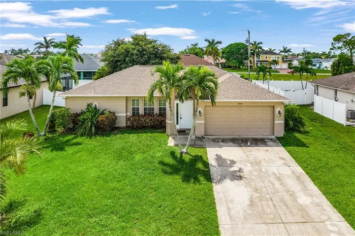 Ranch-style home featuring roof with shingles, concrete driveway, stucco siding, and an attached garage